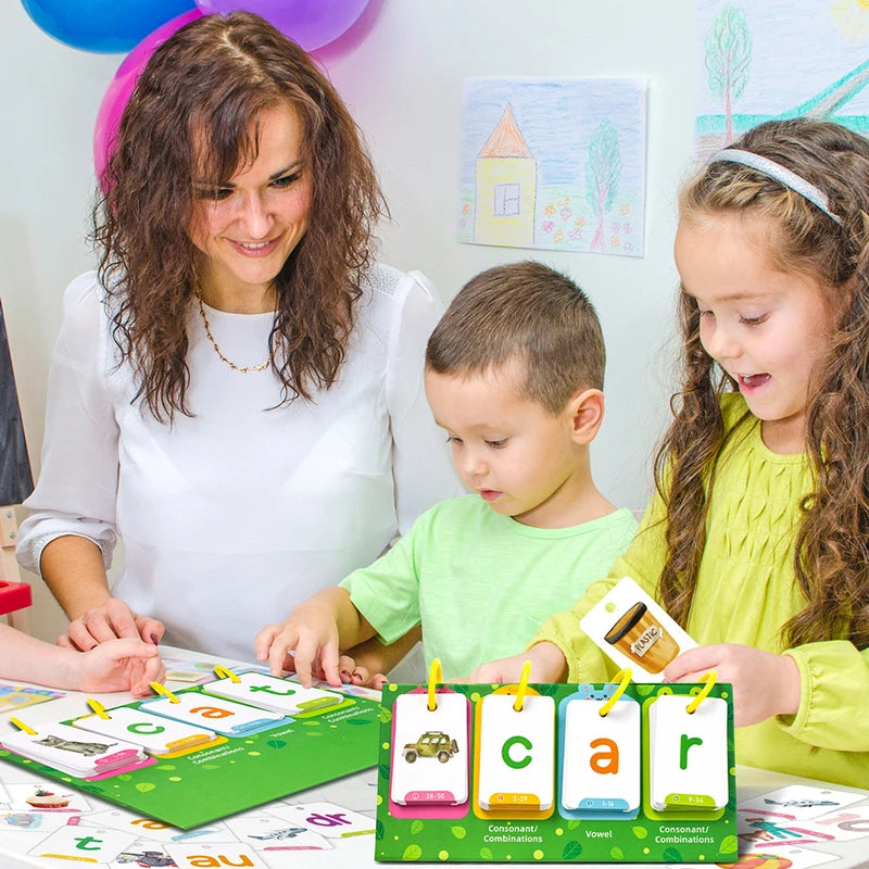 A woman and two children are using CVC word flashcards for early reading and phonics practice.