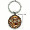 Silver key chain featuring a detailed depiction of Saint Michael the Archangel with wings and a lion.