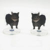 A black cat figurine mounted on a clear acrylic base, designed as a dashboard ornament.