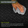 A hand is wiping a dark gray interlocking EVA foam exercise mat with a gray cloth, emphasizing its water-resistant and easy-t