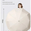 A beige buckle automatic umbrella is shown open, demonstrating its large canopy size and folding mechanism.
