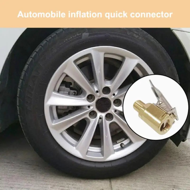 A close-up view of a brass tire inflator chuck with a quick-connect clip shown on a car wheel.