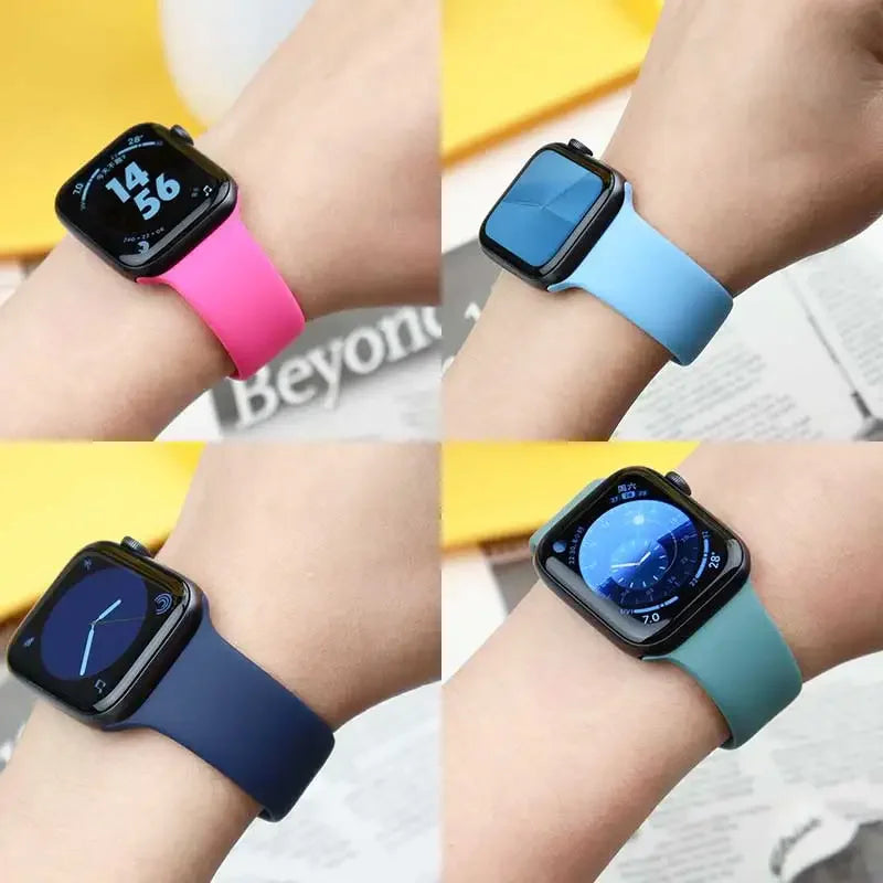 A collection of Apple Watches in various colors and bands, including pink, light blue, and dark blue.