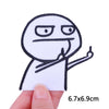 A white embroidered patch of a cartoon cat character with a surprised expression and an outstretched finger.