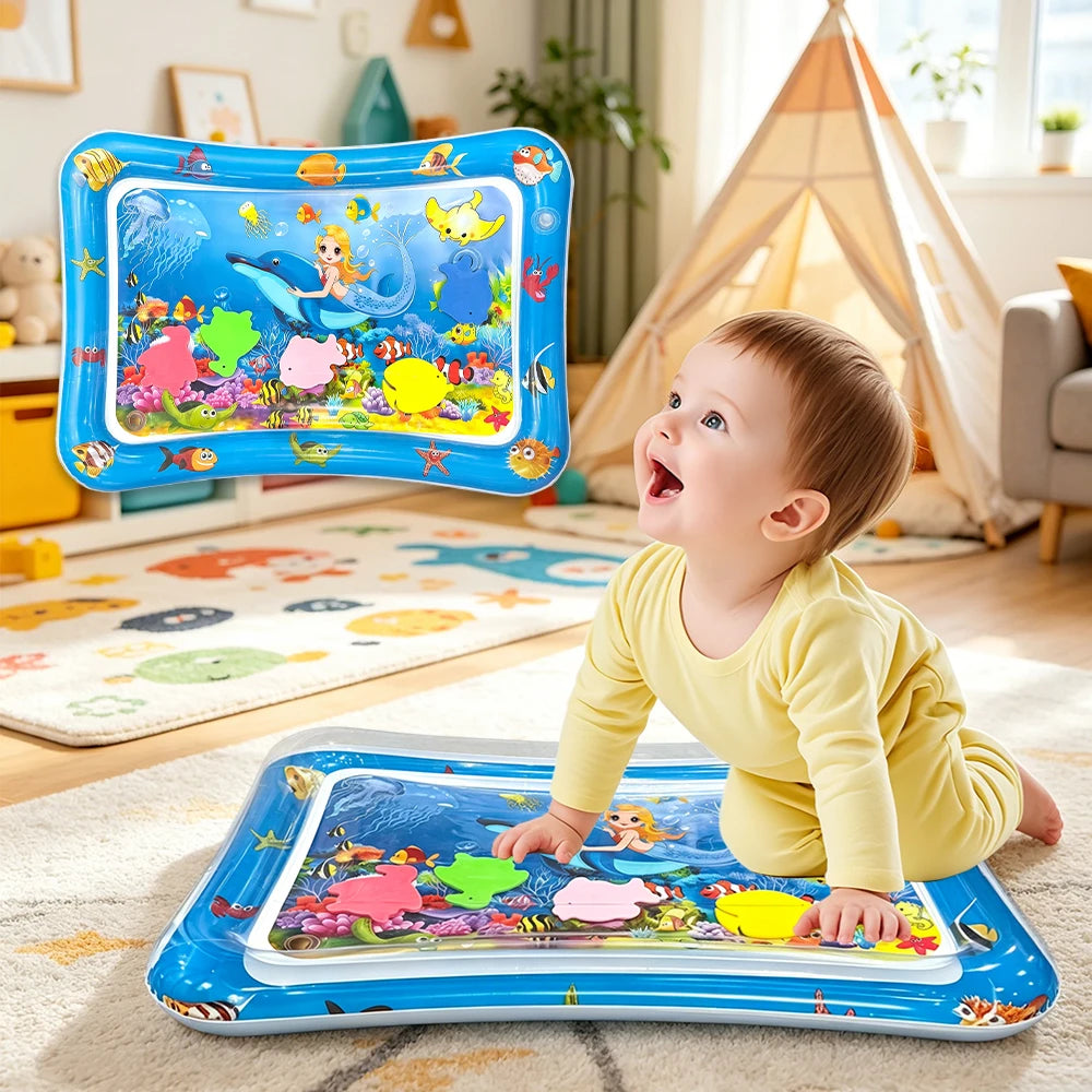 A baby is playing with an inflatable ocean-themed water play mat featuring colorful sea creatures and marine life.