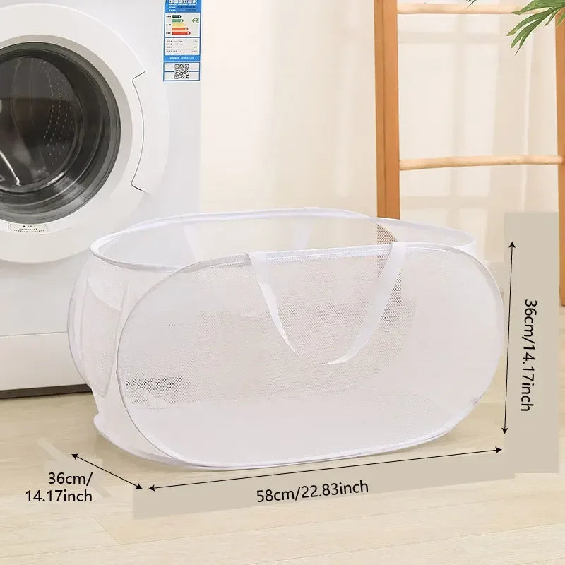 A white folding mesh laundry basket with handles shown next to a washing machine.