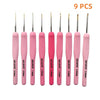 A set of nine pink Tunisian crochet hooks with various sizes and lengths.