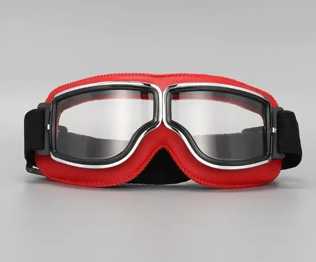 A pair of red retro foldable motorcycle goggles with silver frames and black straps.