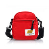 A bright red Japanese style mini canvas crossbody bag with black strap and hardware.