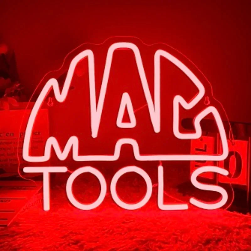 A bright red neon sign spelling out MAP TOOLS is displayed on a surface.