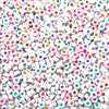 A close-up view of small white acrylic letter beads in various colors like pink, yellow, green, and blue.