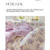 A close-up of a floral duvet cover set in soft lavender and cream tones, featuring purple and green floral patterns.