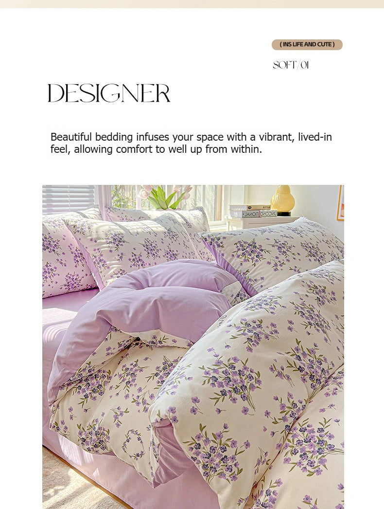 A close-up of a floral duvet cover set in soft lavender and cream tones, featuring purple and green floral patterns.