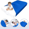 A boy is lying on a blue breathable stretchy sensory bed sheet for restful sleep.