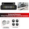 A black tire pressure monitoring device displays pressure readings and includes four batteries for external sensors.