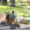 A black portable quiet fly repellent fan with a soft blade is shown next to potted plants and fabric.