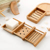 A wooden bamboo soap dish with a slotted design and drainage for natural soap.