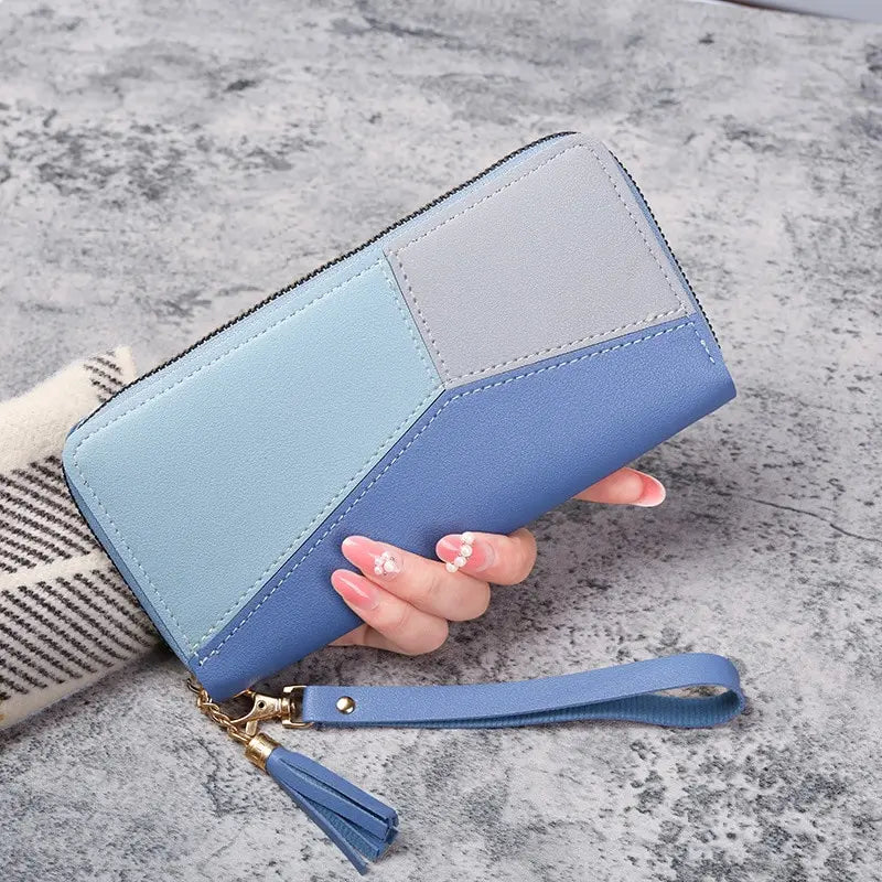 A light blue and gray checkered PU leather wallet with a gold-toned strap is shown on a gray surface.