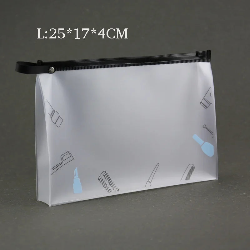 A transparent toiletry bag with a black zipper and hanging hooks is shown against a gray background.
