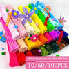 A collection of colorful chenille craft stems in various shades of pink, purple, yellow, green, and blue.