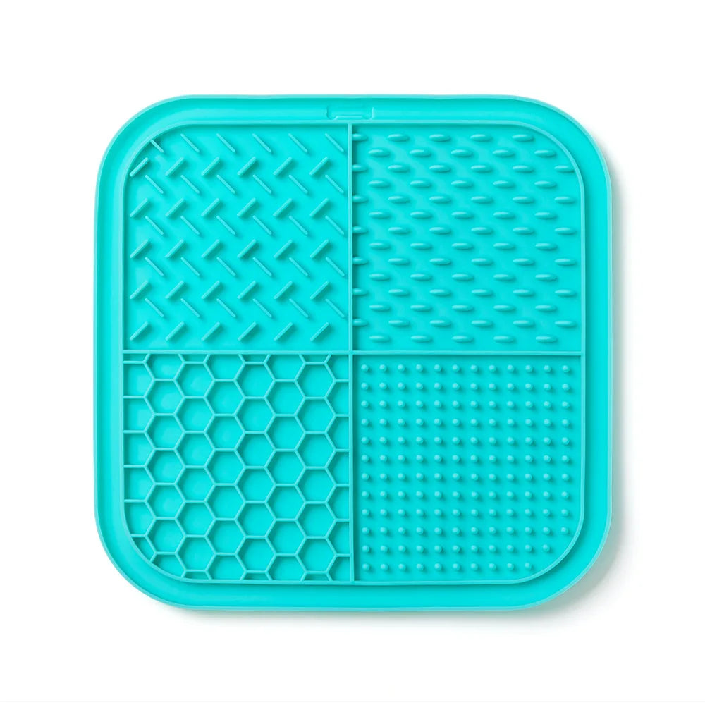 A teal silicone lick mat for pets featuring various textured patterns and suction cups.