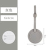 A gray PU leather luggage tag with a round design and a strap, shown against a light gray background.