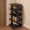 A dark gray stackable vertical shoe rack with four tiers holding various pairs of shoes.