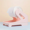 A pink 2-in-1 thermal label holder designed to hold rolls and fan-folded labels.