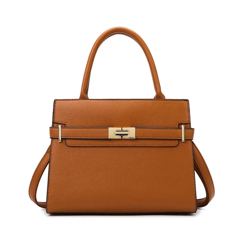 A tan leather handbag with a top handle and matching coin purse.