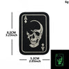 Black embroidered patch featuring a skull design of the Ace of Spades with hook and loop backing