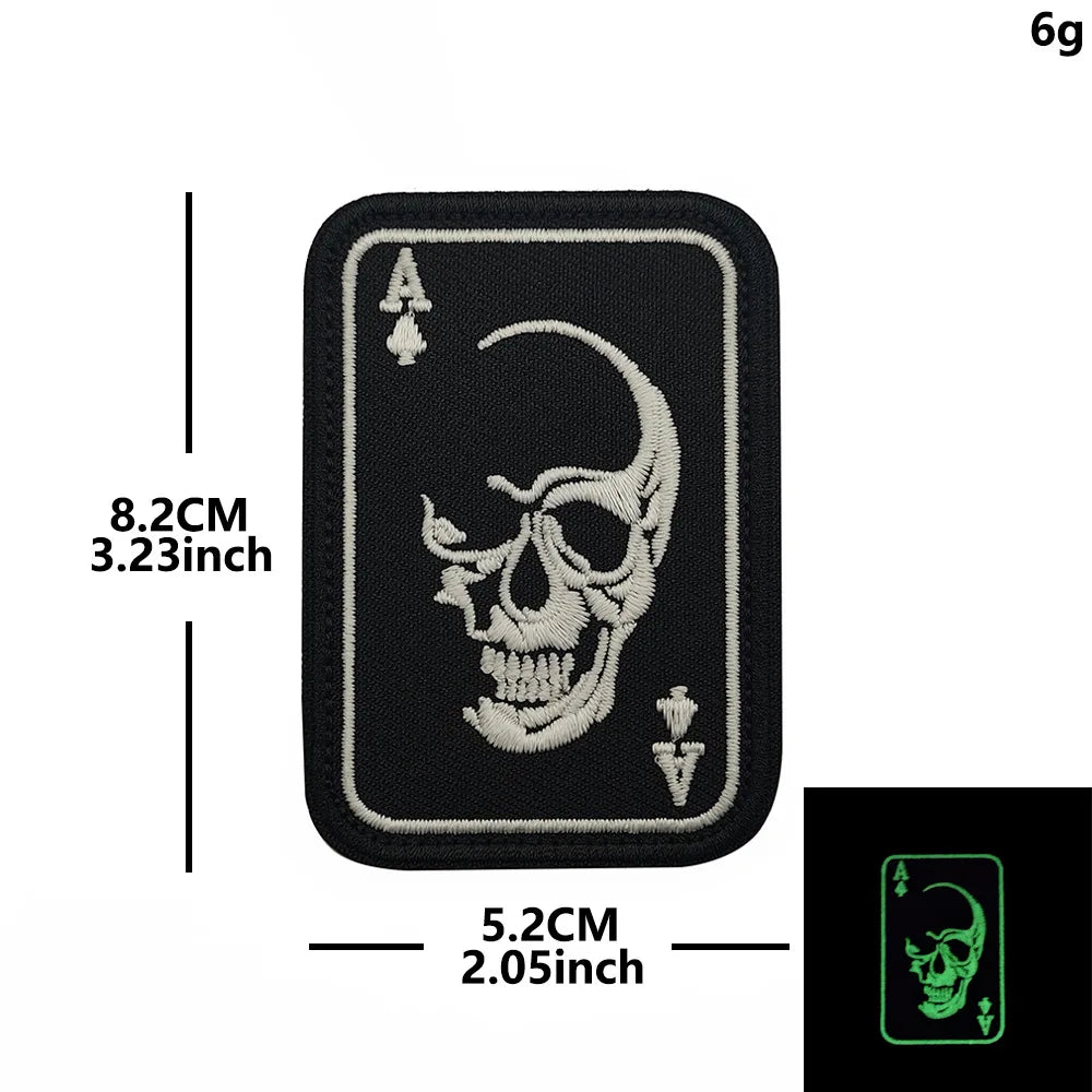 Black embroidered patch featuring a skull design of the Ace of Spades with hook and loop backing