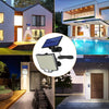 A solar powered motion sensor flood light with a detachable panel illuminating an outdoor area.