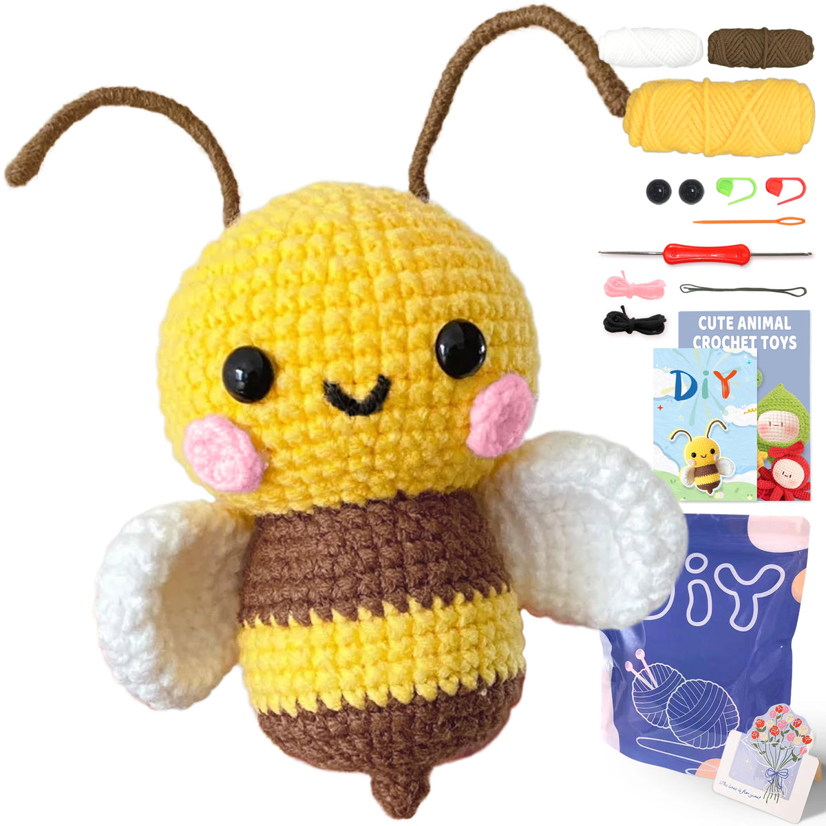 A yellow and brown crocheted bee toy with wings, accompanied by yarn and tools for crafting.