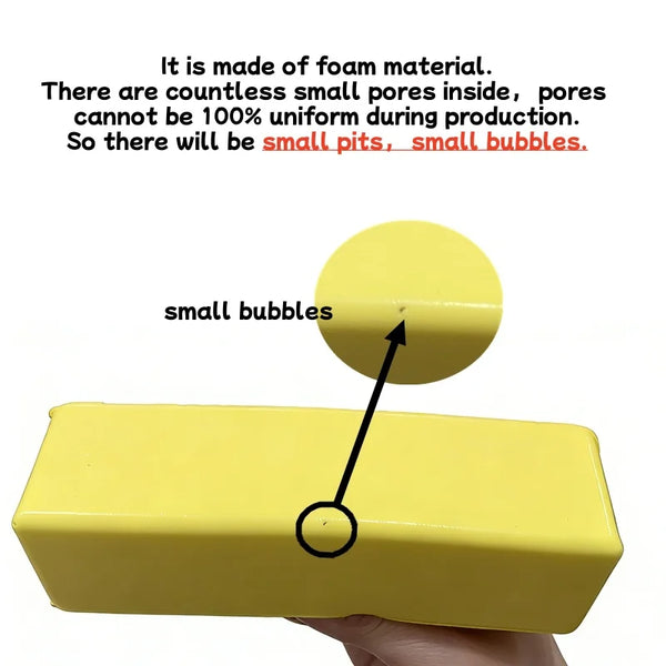A yellow foam butter stick squishy toy being held by a hand.