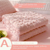 Pink bubble yarn summer cool quilt stacked on a surface with a bowl of green seeds.