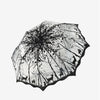 A retro transparent arch umbrella featuring a black and white floral or tree branch design.