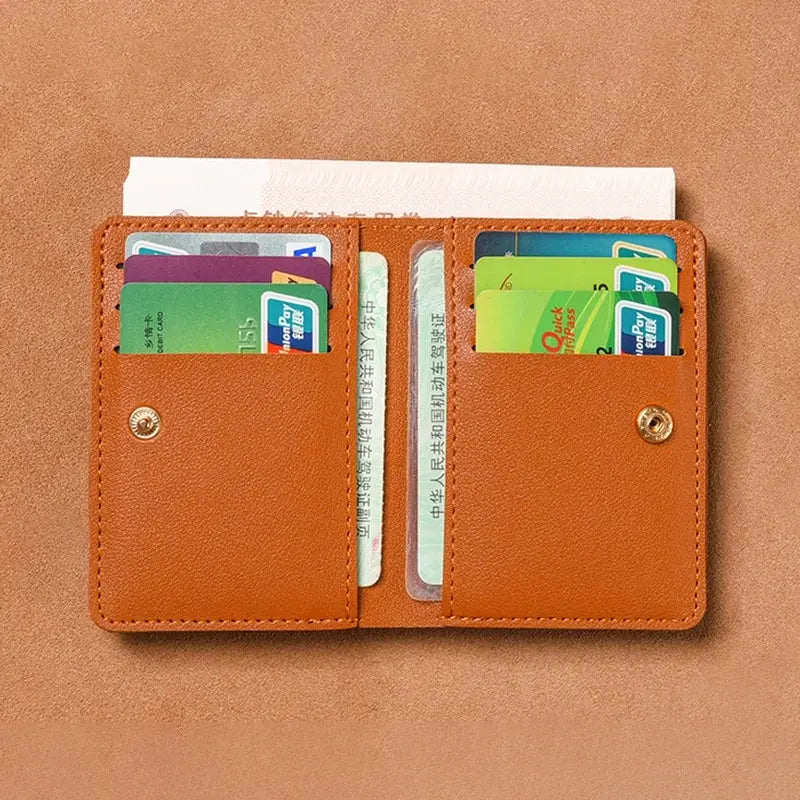 An open brown PU leather compact wallet displaying several credit cards and an ID card.