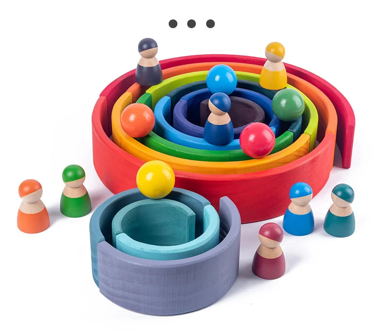 A colorful wooden rainbow stacking block set with various colored wooden stacking blocks arranged in a circular pattern.