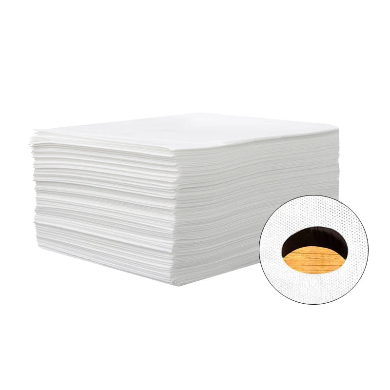 A stack of white disposable bed sheets with a circular cutout showing the rolled fabric.