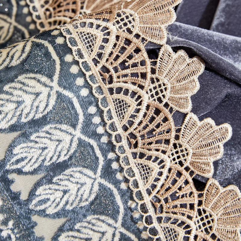 Close-up of a dark gray fabric featuring delicate beige lace trim on the edge.