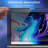 A hand is applying a magnetic privacy screen protector to a laptop display showing colorful liquid art.