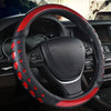 A close-up view of a black steering wheel with red heart-shaped accents and leather trim.