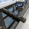 Black marble peel-and-stick wallpaper used as a countertop surface in a kitchen setting.