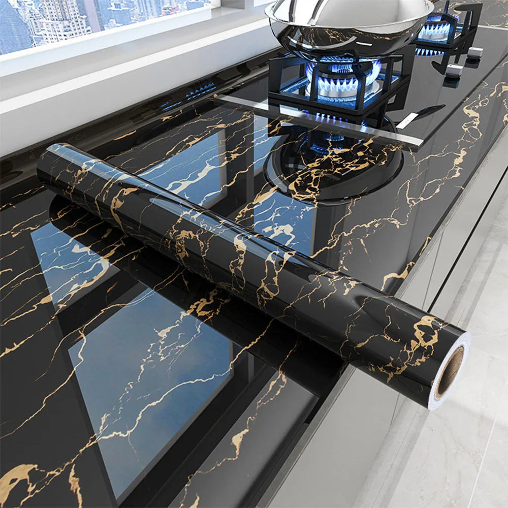 Black marble peel-and-stick wallpaper used as a countertop surface in a kitchen setting.