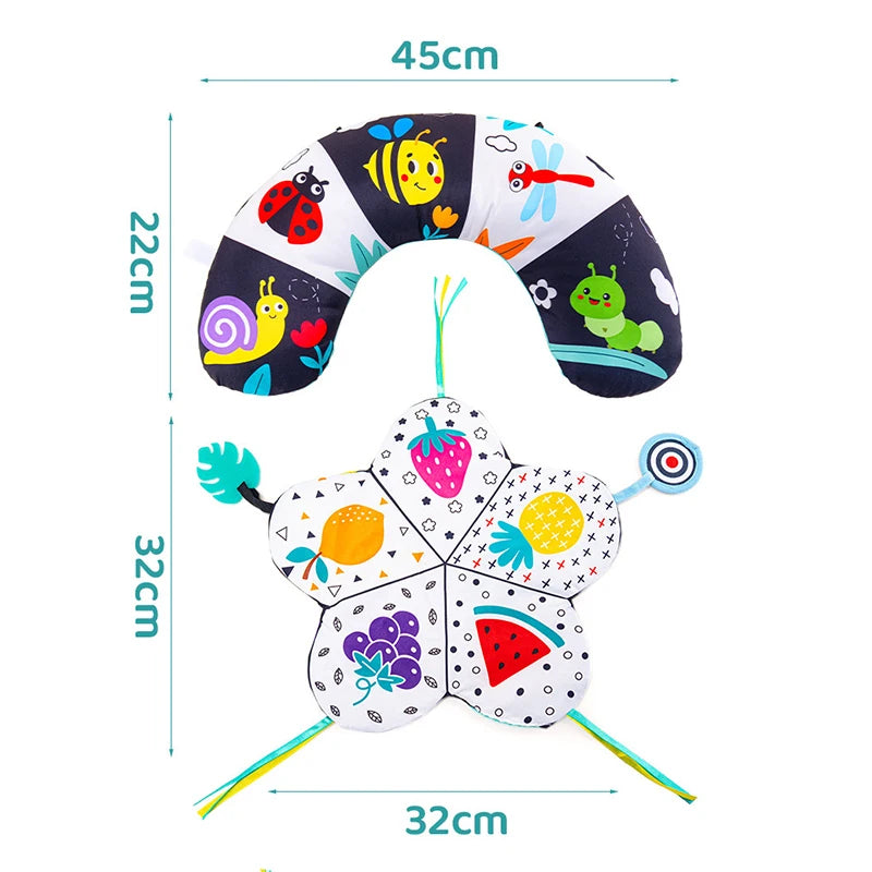 A black and white high contrast tummy time pillow featuring various colorful fruit and insect designs.