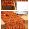 Orange felt table runner with pumpkin designs for Halloween and Thanksgiving