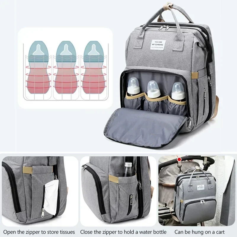Gray backpack diaper bag with an interior changing mat and storage pockets