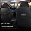 Interior view of a car seat with black covers, showing reserved storage bags and fully enclosed back protection.