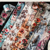 A collection of floral collage style botanical washi tapes featuring various pink, red, and cream flowers and foliage.