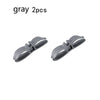 Two gray cord organizers or wire winders for tidy cable management.